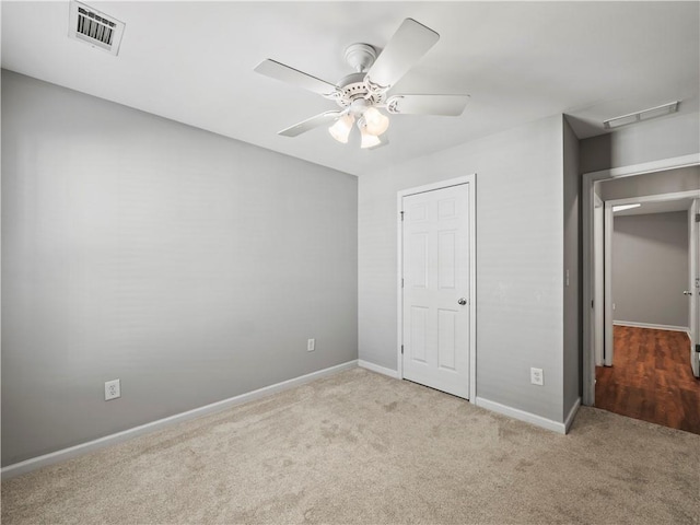 498 Walnut Woods Dr, Braselton, GA 30517 - unfurnished bedroom featuring carpet floors, a ceiling fan, baseboards, and visible vents