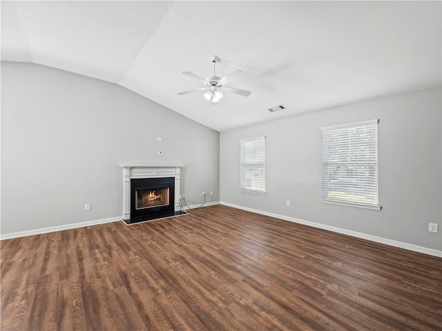 498 Walnut Woods Dr, Braselton, GA 30517 - unfurnished living room with visible vents, lofted ceiling, ceiling fan, a warm lit fireplace, and dark wood-style floors
