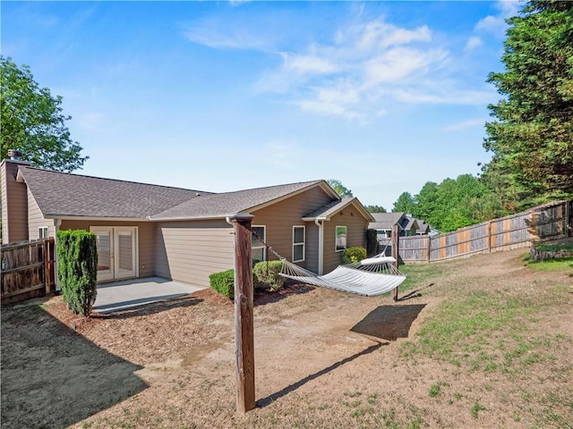 498 Walnut Woods Dr, Braselton, GA 30517 - back of property featuring a lawn, a fenced backyard, a patio area, and french doors