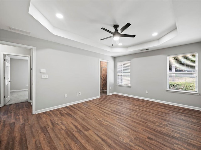 498 Walnut Woods Dr, Braselton, GA 30517 - unfurnished room with visible vents, a raised ceiling, dark wood-style flooring, and baseboards