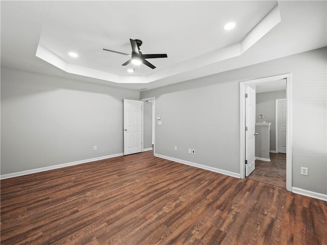 498 Walnut Woods Dr, Braselton, GA 30517 - unfurnished bedroom featuring baseboards, recessed lighting, wood finished floors, and a tray ceiling