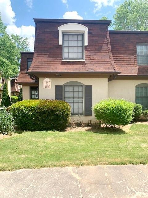 view of property exterior with a yard