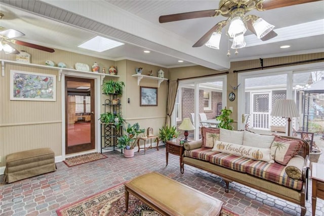 sunroom with a skylight and ceiling fan