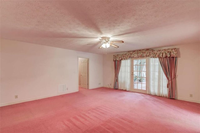 unfurnished room with ceiling fan, carpet flooring, and a textured ceiling