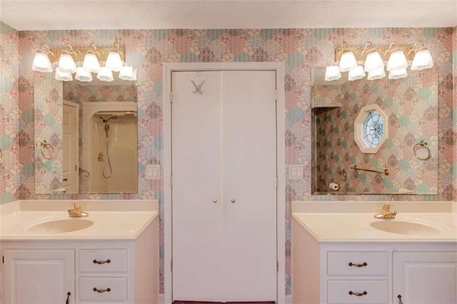 bathroom with walk in shower and vanity