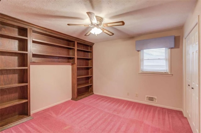 unfurnished bedroom with carpet floors, a textured ceiling, and a closet