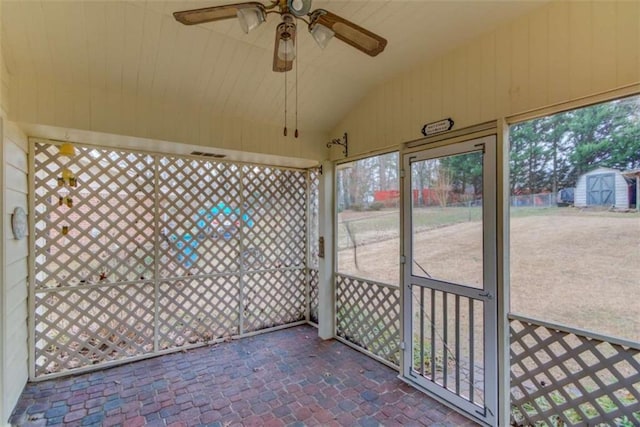 unfurnished sunroom featuring ceiling fan and vaulted ceiling