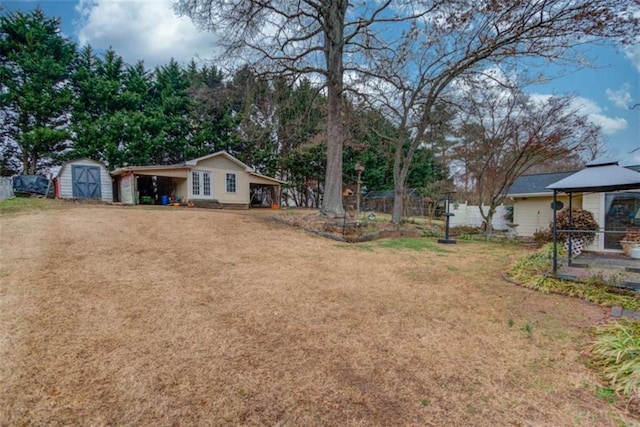 view of yard with a carport and a storage unit