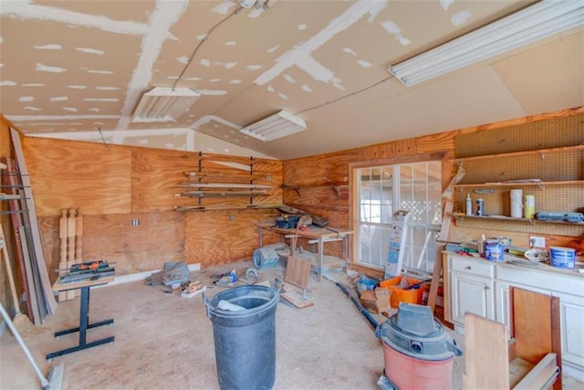 interior space with vaulted ceiling and a workshop area