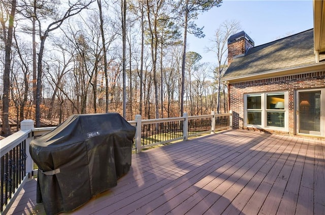 wooden deck featuring grilling area