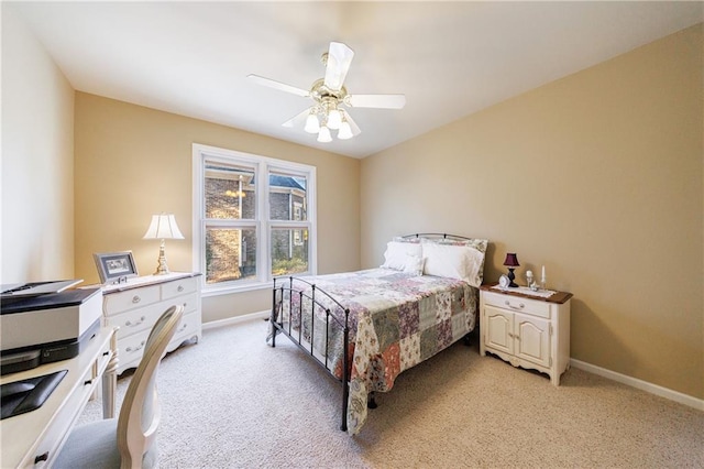 bedroom featuring light colored carpet and ceiling fan