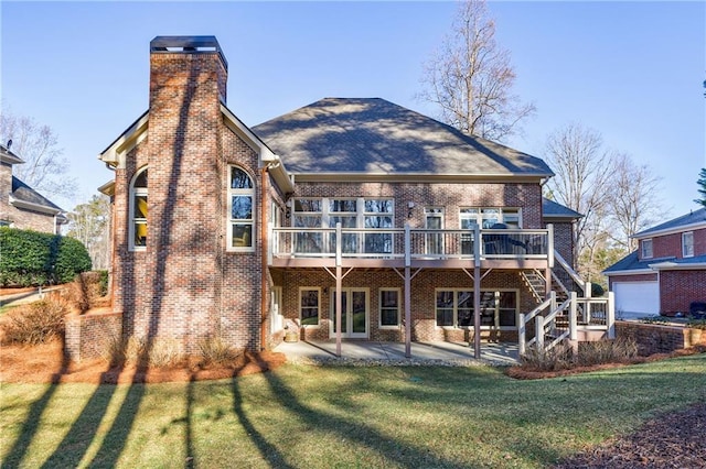 back of house featuring a yard, a deck, and a patio