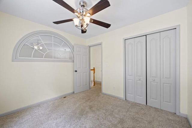 unfurnished bedroom featuring carpet flooring, a closet, and ceiling fan