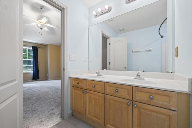 bathroom with ceiling fan and vanity