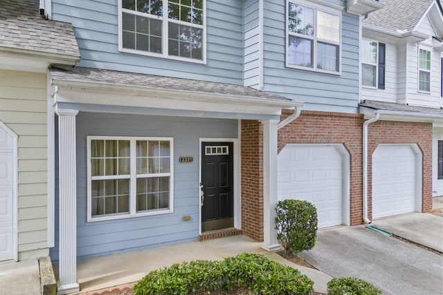 view of exterior entry with a garage