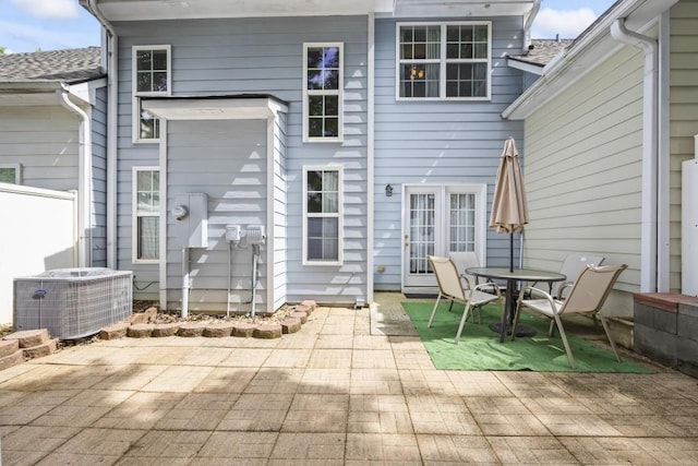 rear view of house featuring central air condition unit and a patio area