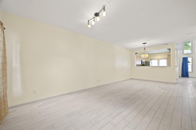 unfurnished living room featuring light hardwood / wood-style floors and track lighting