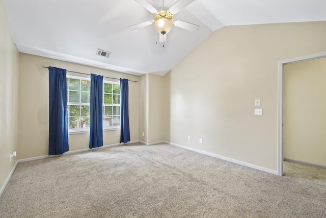 empty room with ceiling fan, carpet, and lofted ceiling