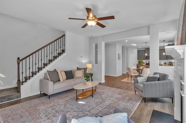 living room featuring dark hardwood / wood-style flooring and ceiling fan