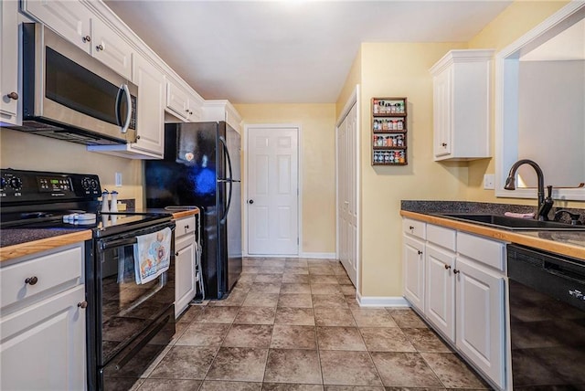 287 Jeremy Dr, Colbert, GA 30628 - kitchen featuring black appliances, a sink, white cabinets, and baseboards