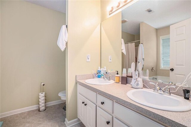 287 Jeremy Dr, Colbert, GA 30628 - bathroom with toilet, double vanity, baseboards, tile patterned flooring, and a shower with shower curtain