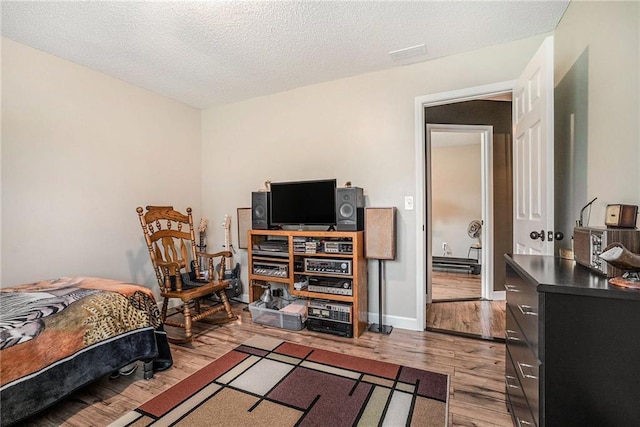 287 Jeremy Dr, Colbert, GA 30628 - bedroom featuring wood finished floors and a textured ceiling