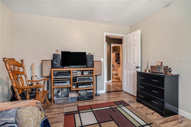 287 Jeremy Dr, Colbert, GA 30628 - bedroom featuring light wood-style floors, baseboards, and a textured ceiling