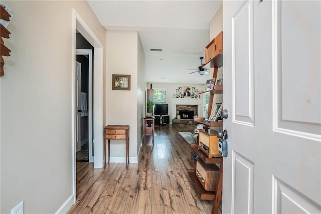 287 Jeremy Dr, Colbert, GA 30628 - foyer featuring wood-type flooring, a fireplace, ceiling fan, and baseboards