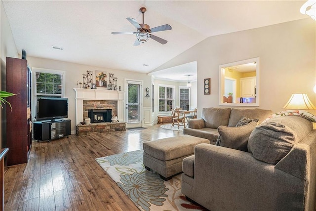 287 Jeremy Dr, Colbert, GA 30628 - living area with wood-type flooring, ceiling fan, lofted ceiling, and a stone fireplace