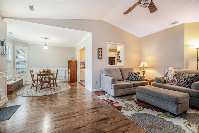 287 Jeremy Dr, Colbert, GA 30628 - living area with vaulted ceiling, wood finished floors, ceiling fan, and a wainscoted wall