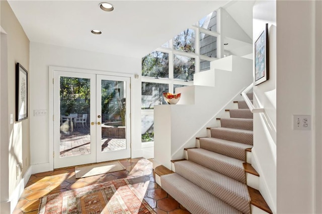 entryway with tile patterned flooring and french doors