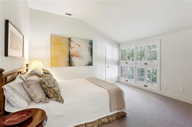 bedroom featuring carpet and lofted ceiling