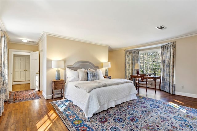 bedroom with dark wood-type flooring and ornamental molding