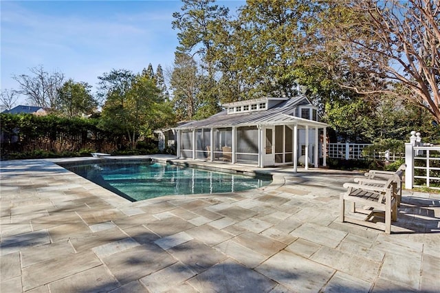 view of pool with a diving board and a patio area