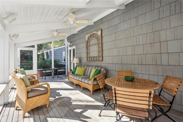 sunroom featuring lofted ceiling with beams