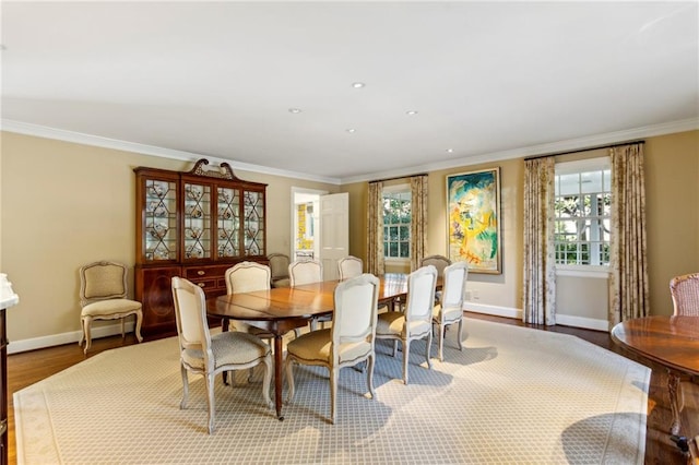 dining area featuring hardwood / wood-style flooring and crown molding