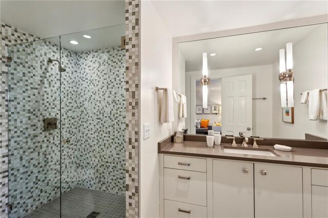 bathroom featuring vanity and an enclosed shower