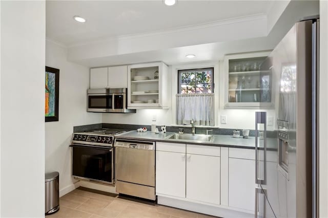 kitchen featuring crown molding, sink, light tile patterned flooring, white cabinetry, and stainless steel appliances