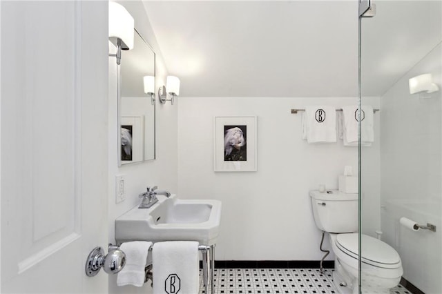 bathroom with toilet, lofted ceiling, and a chandelier