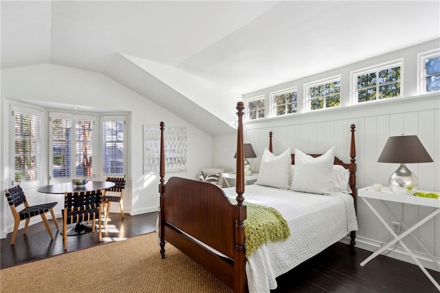 bedroom with dark hardwood / wood-style flooring, multiple windows, and lofted ceiling