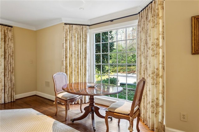 dining room with hardwood / wood-style flooring and ornamental molding