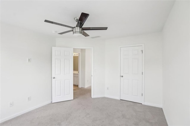 unfurnished bedroom featuring a ceiling fan, baseboards, visible vents, and light carpet