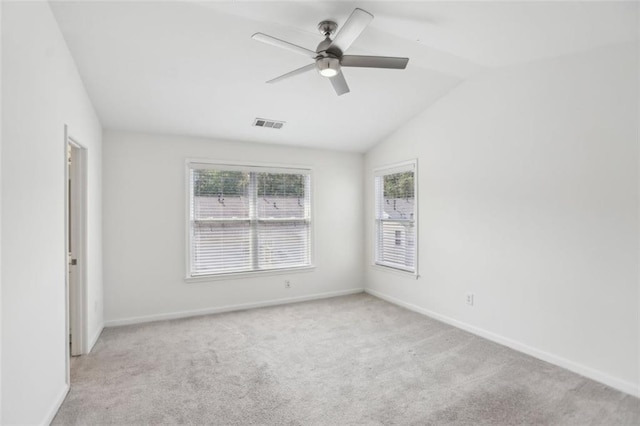 spare room featuring baseboards, a ceiling fan, carpet, and vaulted ceiling