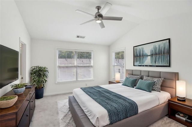 bedroom with ceiling fan, light colored carpet, and lofted ceiling