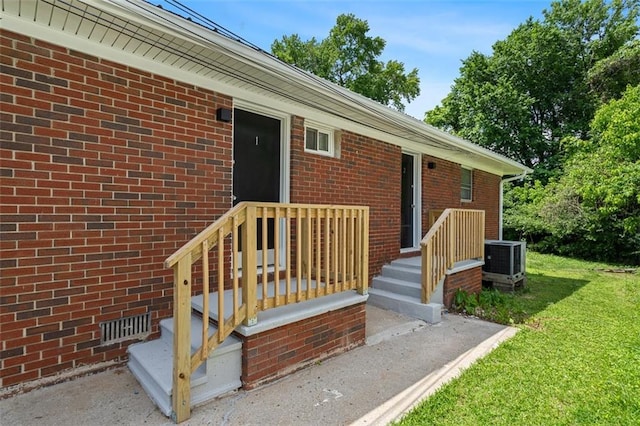 1437 Vesta Ave, East Point, GA 30344 - doorway to property with a lawn, brick siding, and central air condition unit
