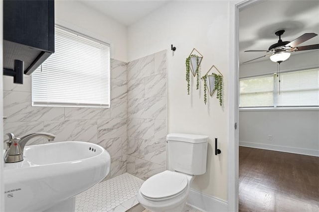 1437 Vesta Ave, East Point, GA 30344 - bathroom featuring a sink, toilet, ceiling fan, wood finished floors, and baseboards