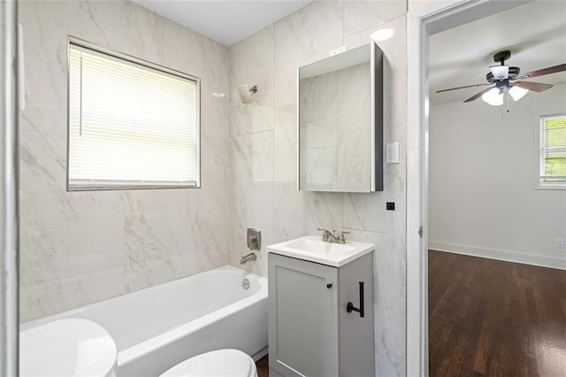 1437 Vesta Ave, East Point, GA 30344 - full bath with toilet, vanity, shower / tub combination, ceiling fan, and wood finished floors