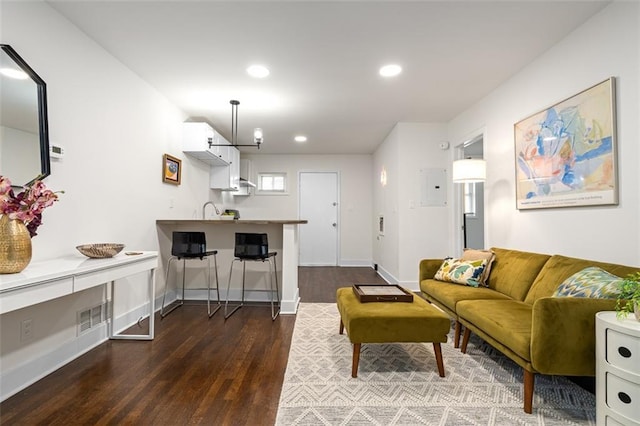1437 Vesta Ave, East Point, GA 30344 - living area with dark wood-type flooring, recessed lighting, electric panel, and baseboards