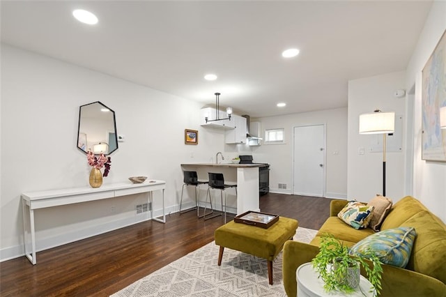 1437 Vesta Ave, East Point, GA 30344 - living area featuring dark wood-style flooring, recessed lighting, and baseboards