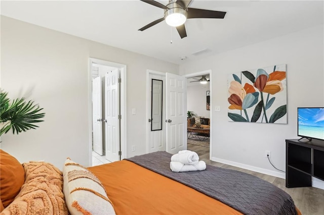 bedroom with wood finished floors, a ceiling fan, and baseboards